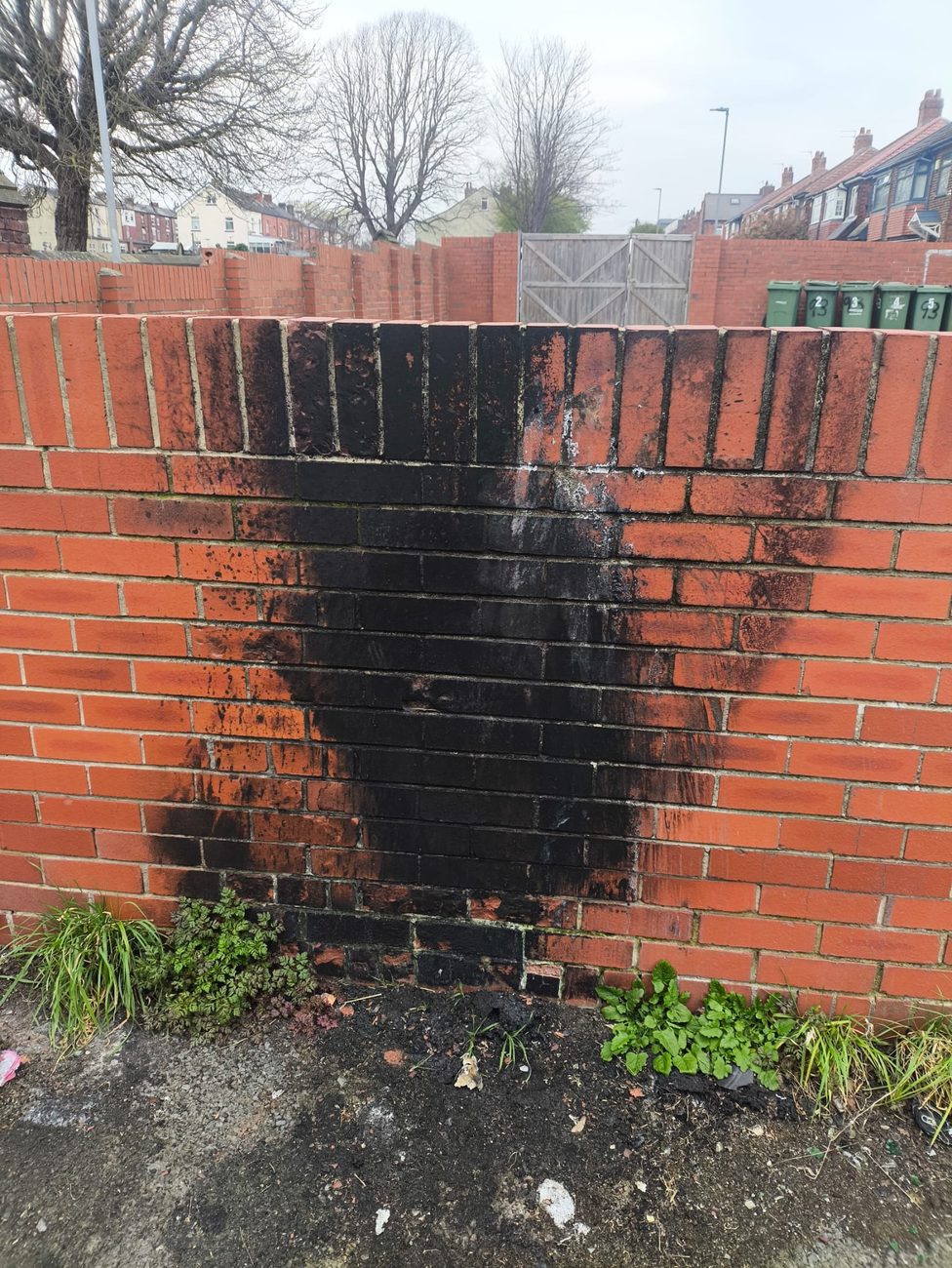 Brick wall with heavy soot staining